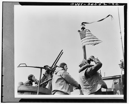 Flags flies over PT boat. In sea warfare since Pearl Harbor, the Navy tinset PT boats have frequently proved to be a deadly match for warships, submarines and merchant men. Their hulls are thin and their sides are small but their offensive and defensive armament is varied and effective. It consists 