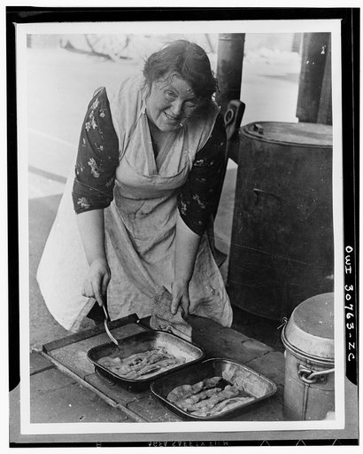 Cook frying American bacon at a feeding centre somewhere in England