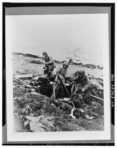 Attu, Aleutian Island, June 4, 1943. Soldiers hurling their trench mortar shells over a ridge into a Japanese position