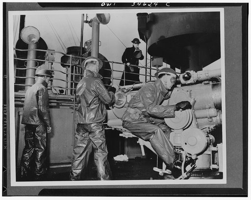 Merchant ship U.S. Navy gun crew getting the range on its four-inch .50 calibre gun on a cold day