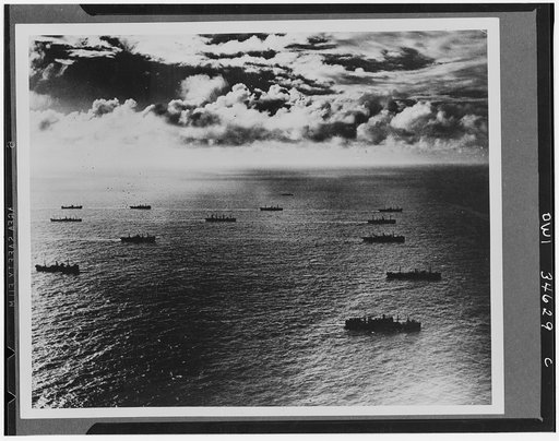 Sturdy cargo ships fill the sea lanes leading to all fronts, bearing guns, tanks, and planes for the United Nations. The Liberty ships are visible in this section of the convoy