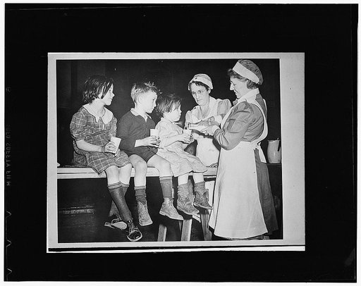 Flood refugees being fed by the Red Cross canteen workers