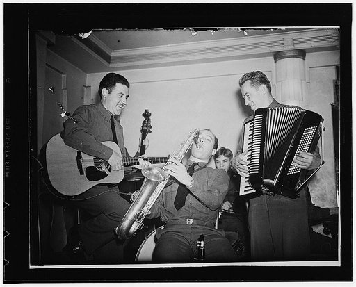 London, England. Three members of the band at the Red Cross Washington club in London. Left to right: Private Jesse Cosrales, of Los Angeles; Private Donald Beverly, of Elgin, Illinois, and Sergeant Pete Balutis, of Kewanee, Illinois