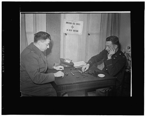 London, England. Lieutenant Samuel Levin, left, of New York City, and Lieutenant Fred O. Wickham, of Jefferson City Missouri, playing a game of dominos