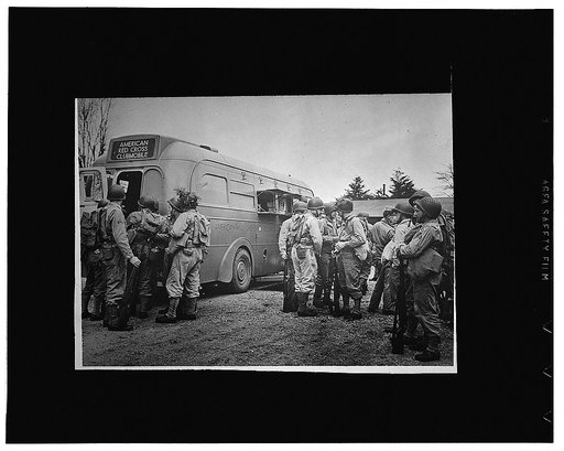 American Red Cross clubmobiles take hot coffee, doughnuts, candy, chewing gum and cigarettes to soldiers in isolated camps where no Red Cross clubs are located
