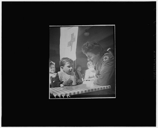 Algiers, Algeria. French children receiving hot milk provided by the Allies and distributed by the Red Cross at a day nursery, on the estate of the former Dey of Algeria