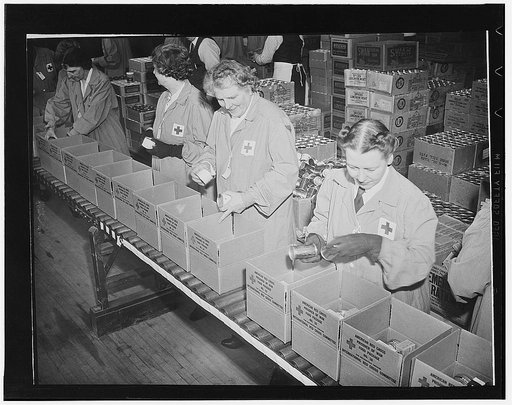 Working in daily squads of eighty, Red Cross women volunteers from all walks of life, can pack parcels at the rate of 2,000 an hour. The packages are destined for American and other Allied soldiers and sailors held in enemy prison camps