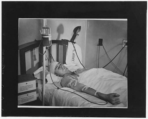 Washington, D.C. First Lieutenant Landis D. Morris, of Olar, South Carolina, wounded by a sniper's bullet at Safe, receiving a transfusion of blood plasma at Walter Reed Hospital