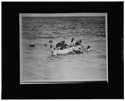 Men learning how to properly enter one of the life rafts on all PBY planes as part of a course in life saving and water safety for sailors at the naval operating base at Key West, Florida, under the supervision of C. Ben Stanton