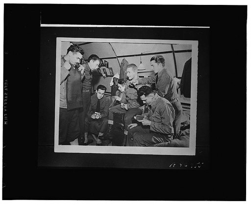 Soldiers of the Iceland base command receiving gift boxes of sweaters and bags containing cigarettes, soap, sewing kits and other comforts from  the Cleveland, Ohio, and New Haven, Connecticut, Red Cross chapters