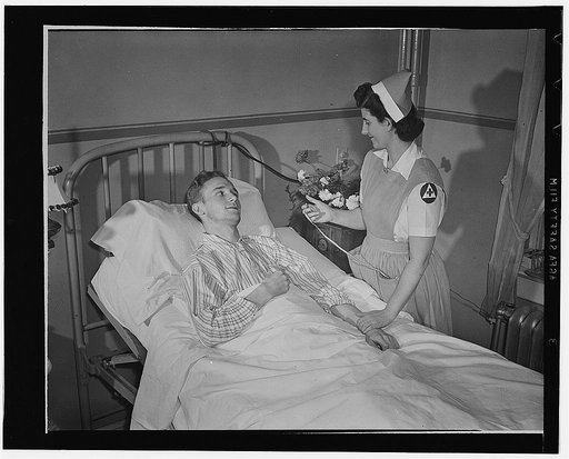 Washington, D.C. A Red Cross nurse's aide taking a patient's pulse. Women between 18 and 50, who volunteered tlike this one for the 80-hour trainign course and 150-hour yearly service in hospitals, help to relieve the nurse shortage