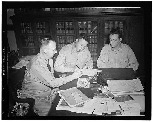 Lake Charles, Louisiana. A Red Cross field director arranging for train fare to a draftee suddenly called home for a family emergency