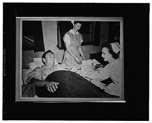 Palo Alto, California. Frankie Albert, Stanford's All-American quarterback, and two nurses. He was one of the first to make an appointment to give his blood to the Red Cross blood donor service when the mobile unit visited Palo Alto