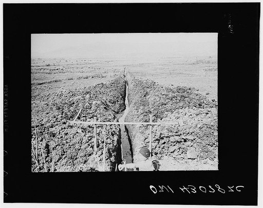 Public Health Serive Investigation Commission to the China-Burma higway, Chefang Valley, China. Long straight ditch the morning after it had been dug. The soil is so soft that the walls shift in one night whenever there is action by small springs