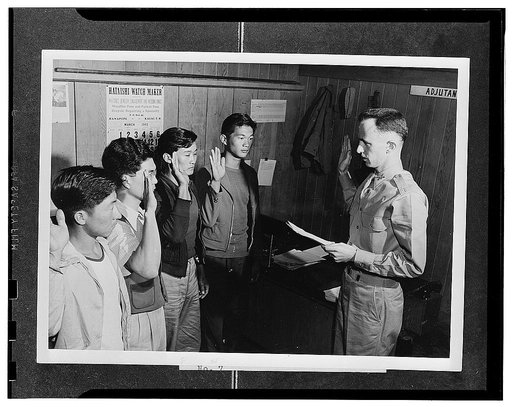 Kauai District, Territory of Hawaii. Major Charles V. McManus administering the oath to four AJA volunteers