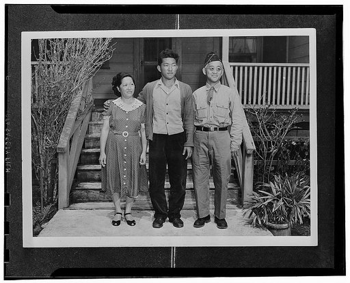 Kauai District, Territory of Hawaii. Herbert Kondo, an AJA volunteer, with his father and mother. The elder Kondo is a veteran of World War I