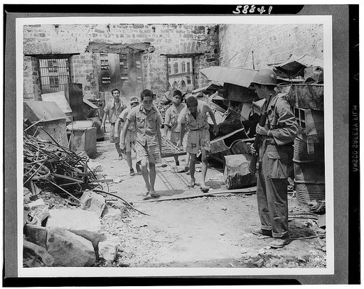 Japanese prisoners of war being guarded by Americans--probably in the Philippines