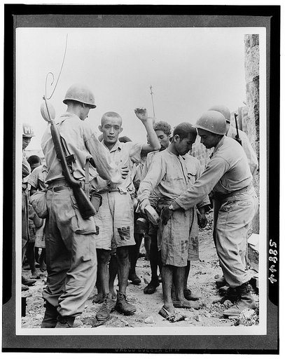 Japanese prisoners of war being guarded by Americans--probably in the Philippines