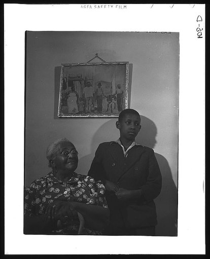 Mrs. Ella Patterson, the oldest resident at the Ida B. Wells Housing Project, Chicago, Illinois, and her grandson. She is 102 years old