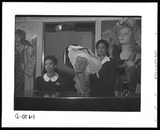 Miss Minnie Coleman (left), clerk, and Miss Selma Barbour (right), manager of the Cecilian Specialty Hat Shop, 454 East 47th Street, Chicago, Illinois