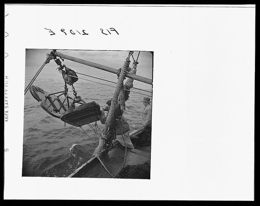 Provincetown, Massachusetts. Aboard the Frances and Marion, a Portuguese drag trawler, fishing off Cape Cod. "Doors," which when lowered, slide over the bed of the ocean like sled runners, dragging behind them the purse seine which scoops up miscellaneous fish, rocks, crabs, lobsters, and a great de