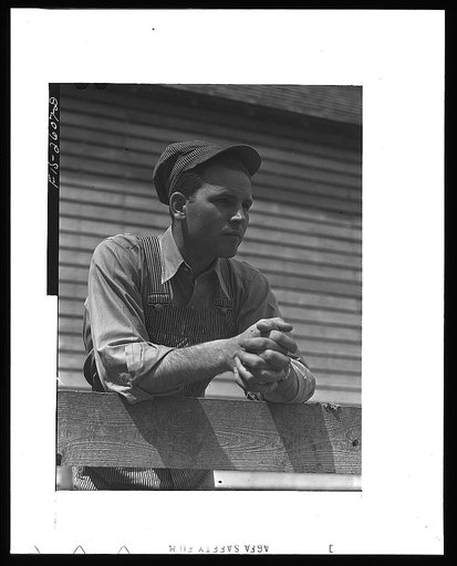 Gene Cooper, student at Iowa State College visits his family on their farm near Ames, Iowa
