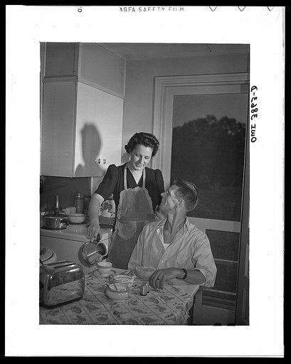 Sheffield, Alabama (Tennessee Valley Authority (TVA)). Mrs. Hall prepares breakfast for her husband before he leaves for work at the aluminum plant