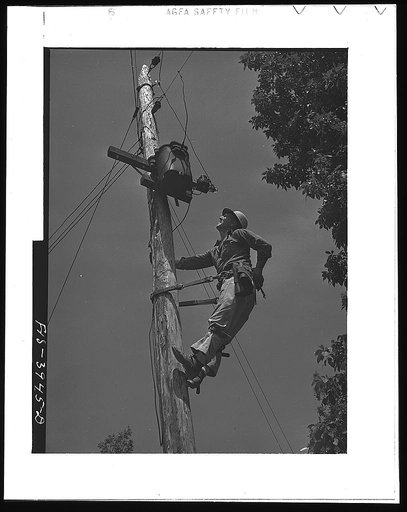 Lauderdale County, Alabama. Tennessee Valley Authority (TVA). Julien H. Case repairing the transformer which brings TVA electricity to his farm. Case uses 900 kilowatt hours each month