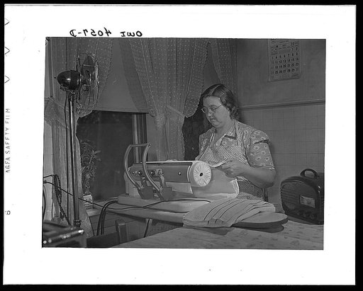 Knox County, Tennessee (Tennessee Valley Authority (TVA)). Mrs. Robert Bacon, farm wife, with some of her electric appliances - fan, ironer, radio
