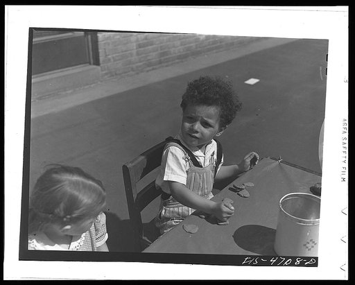 Queens, New York. Child playing with clay at the nursery school at the Queensbridge housing project