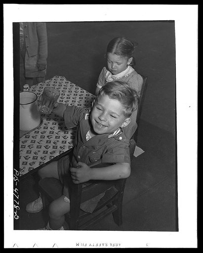 Queens, New York. Children get milk or tomato juice after their nap at the nursery school at Queensbridge housing project