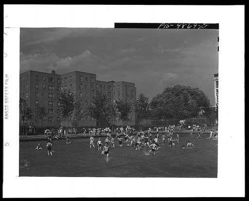 Brooklyn, New York. Red Hook housing development. Children in wading pool at play center which is supervised by the city's Department of Parks. There are separate pools for swimming and diving. Charge is nine cents for children, twenty five cents for adults