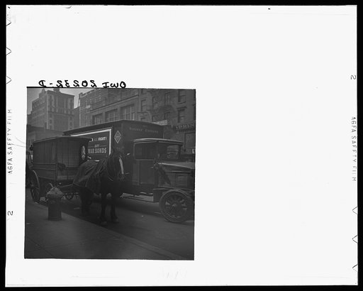 New York, New York. A horse and wagon and a railway express truck