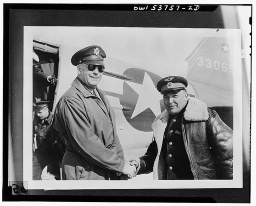 Nome, Alaska. Brigadier General Dave V. Gaffney, commanding general of the Alaskan wing of the Air Transport Command being welcomed by Colonel N.S. Vasin, commander of the Russian detachment