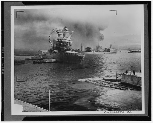 Leaves berth virtually surrounded by stricken ships. The U.S.S. Neosho, navy oil tanker, cautiously backs away from her berth (right center) in a successful effort to escape the Japanese attack on Pearl Harbor, Dec. 7, 1941. At left the battleship U.S.S. California lists after aerial blows. Other cr