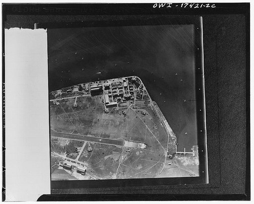 Cagliari, Sardini. 1942(?) This is the way the airdrome and seaplane base appeared from a reconnaissance plane of the 12th US Air Force just before a raid. Note the seaplanes riding at anchor in the harbor