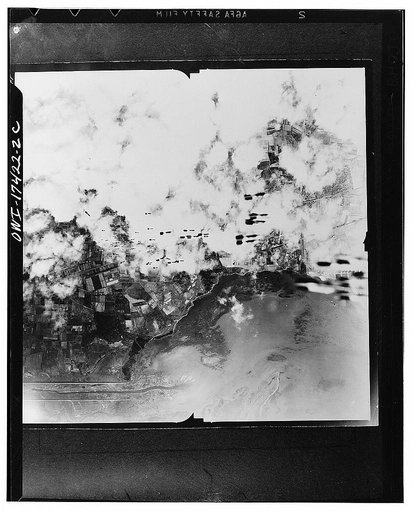Cagliari, Sardinia. 1942(?) Trains of fragmentation bombs aimed at the Cagliari airfield and dispersal area are seen dropping from Flying Fortresses
