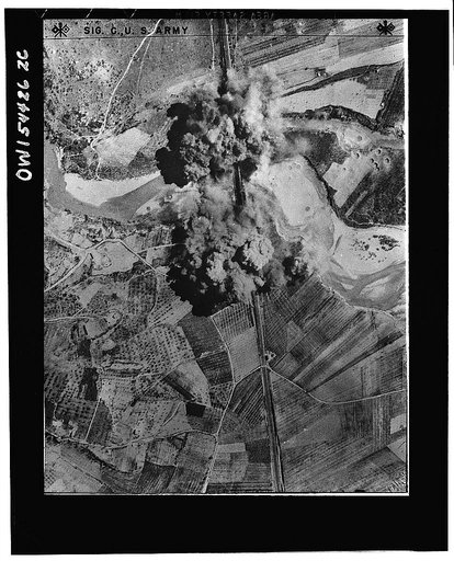 A Nazi bridge is put out of commission. Black smoke engulfs a railway bridge on the line from Florence to Rome after it was straddled by bombs. For two months Allied bombers pounded German railroad installations forcing the enemy to depend increasingly upon cargo vessels and motor vehicles for trans