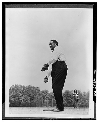Paul Robeson playing softball with other members of Othello production, Central Park, New York City