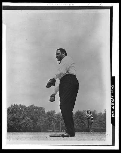 Paul Robeson playing softball with other members of Othello production, Central Park, New York City