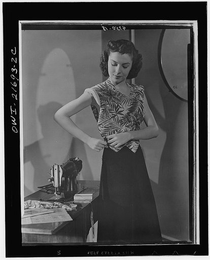Waistline adjustment can usually be made entirely at the easy side seam with no more difficulty than Cynthia appears to be having. By studying intricate print carefully before placing pattern, Cynthia makes very smart use of unusual flower design. Beginners are advised to use  conventional "all-over