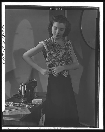 Waistline adjustment can usually be made entirely at the easy side seam with no more difficulty than Cynthia appears to be having. By studying intricate print carefully before placing pattern, Cynthia makes very smart use of unusual flower design. Beginners are advised to use  conventional "all-over