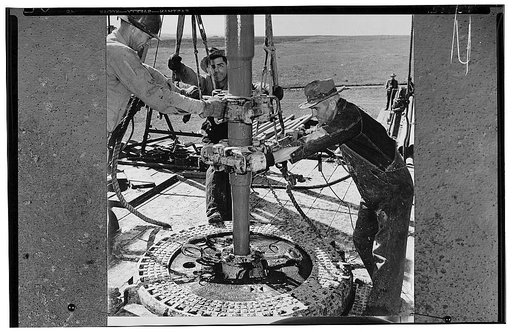 America's petroleum industries pour out fuel and lubricants for the United Nations. At an oil well in the U.S. Southwest state of Oklahoma, oil drillers are using tools called "tongs" which are clamped on the drill stem to screw on a new section of stem or to unscrew the stem, section by section, af