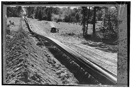 America's petroleum industries pour out fuel and lubricants for the United Nations. Over hills and mountains, across broad rivers and through densely weeded regious runs what the U.S. calls the "Big Inch," the largest oil pipeline in the world, built specially to expedite supplies of oil derivatives