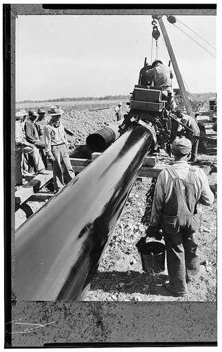 America's petroleum industries pour out fuel and lubricants for the United Nations. The largest oil pipeline ever laid runs from the U.S. southwest state of Texas eastward to the Atlantic coast, a distance of almost 1,400 (2240 kilometers) miles, over which 300,000 barrels of oil every day is being 