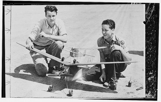 America's youth builds and flies model planes on miniature flying fields. Two young members of the San Antonio Gas Model Club display the model planes they have designed and constructed in home workshops and brought to Kelly Field in the City of San Antonio in the southwestern U.S. state of Texas fo
