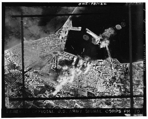 The deadly marksmanship of the United States Army Air Force bombers is graphically illustrated in this picture just received from North Africa. It shows direct hits on harbor warehouses and terminals and a pierhead at Sousse, the important Axis-held Mediterranean seaport in Tunisia