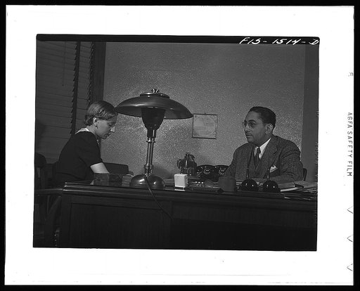 Mr. Albert W. Williams, president of the Unity Life Insurance Company, dictating to secretary DeAcklin. Mr. Williams was born in Georgia, studied at the University of Pennsylvania, worked for eight years for an insurance company in Washington, D.C. then went to New Orleans, and for the last fifteen 