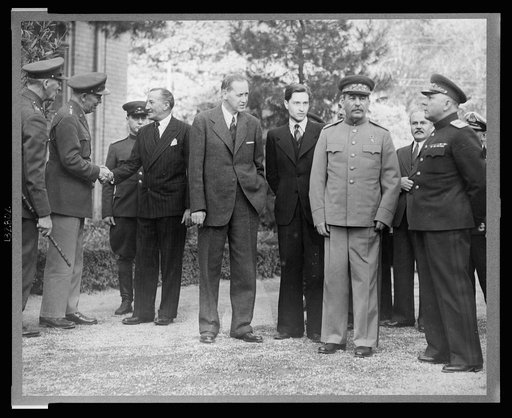 Teheran, Iran. Dec. 1943. Standing outside the Russian Embassy, left to right: unidentified British officer, General George C. Marshall, Chief of staff of USA, shaking hands with Sir Archibald Clark Keer, British Ambassador to the USSR, Harry Hopkins, Marshal Stalin's interpreter, Marshal Josef Stal