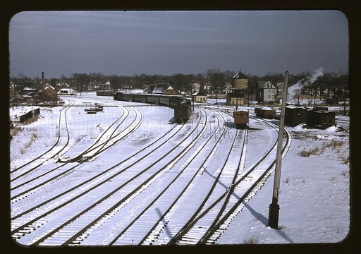 Train and several sets of railroad tracks in the snow, Massachusetts